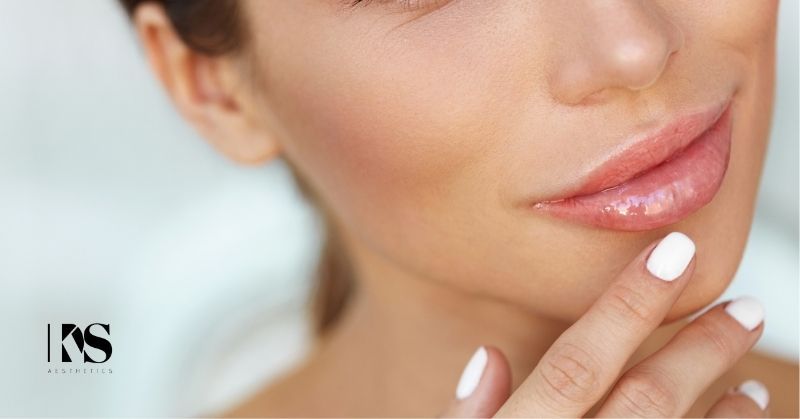 Woman is happy with her full lips after deciding between fat transfer versus lip filler. KDS Aesthetics logo sits at bottom left.